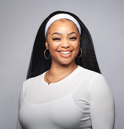 a photo of a smiling women wearing a white shirt