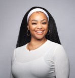 a photo of a smiling women wearing a white shirt