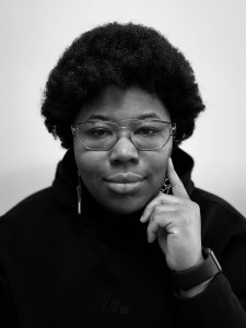 a black and white photo of a women wearing glasses