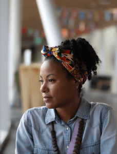 a photo of a women wearing jeans shirt looking to her right side